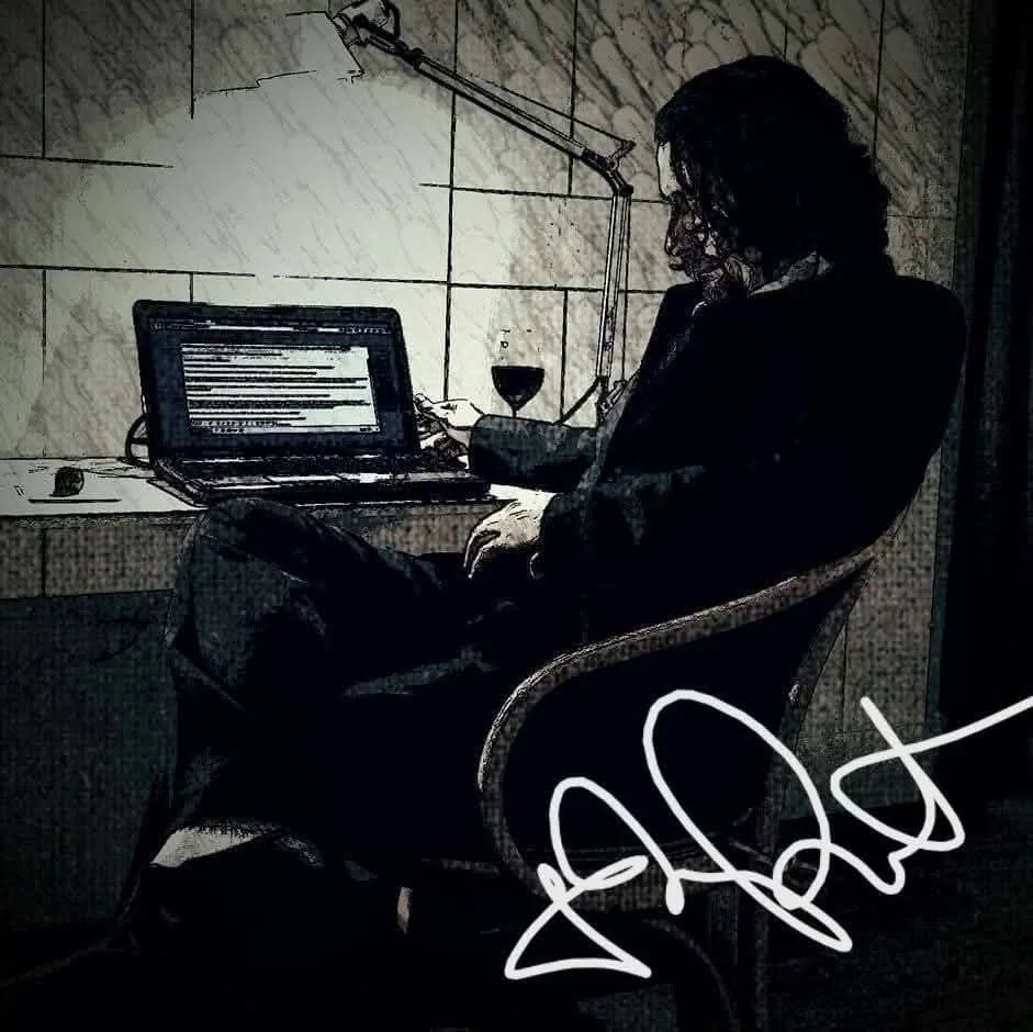 Eliahi working at a laptop in warm evening light